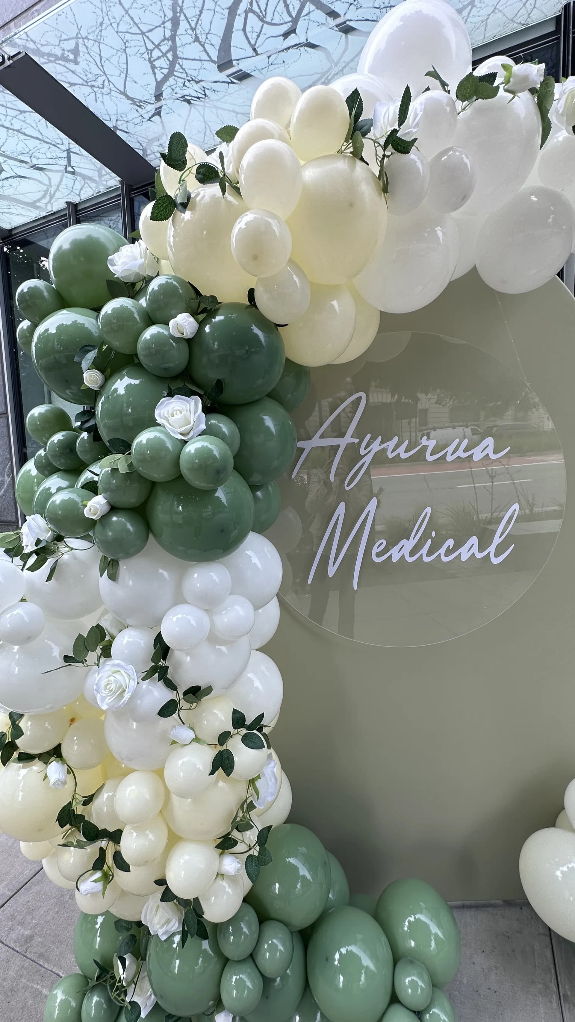 Salon Grand Opening in San Francisco, California: organic balloon arch and branded backdrop, view 2 of 8.