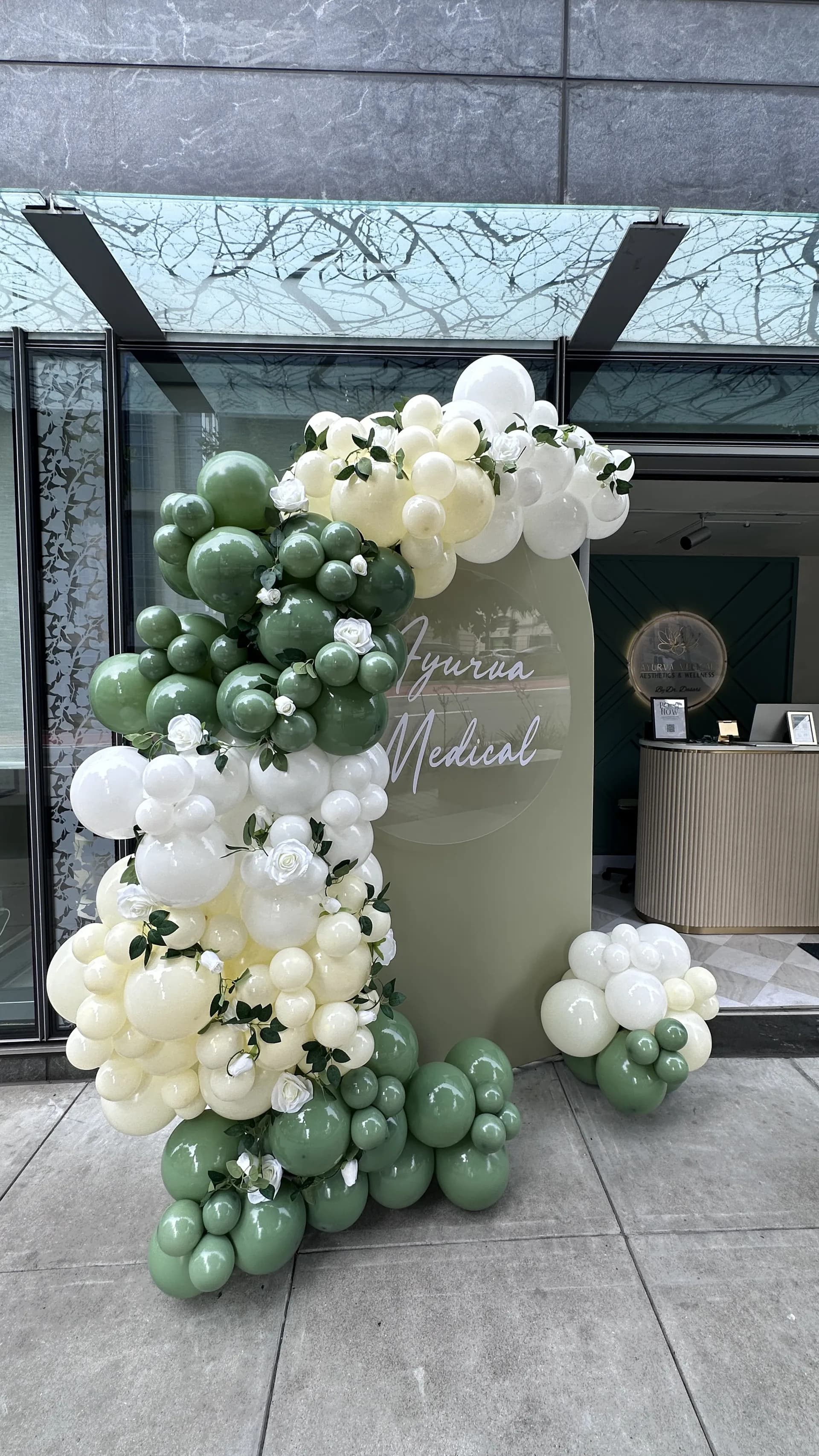 Organic balloon arch and branded backdrop produced by Balloon Décor for a corporate client in San Francisco, California, view 3.