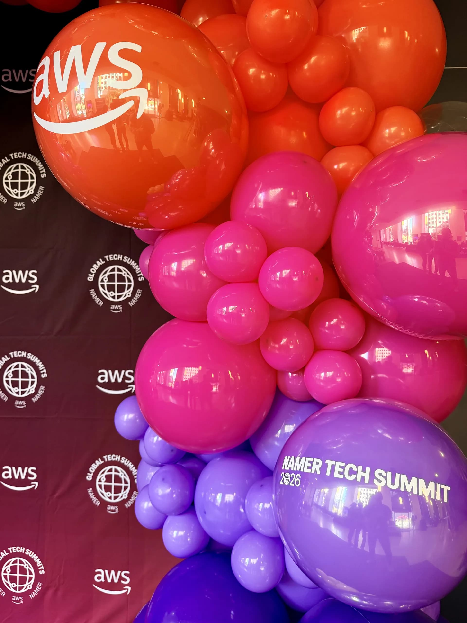 Two statement balloon arches and a branded photo zone produced by Balloon Décor for AWS in San Francisco, California, view 3.