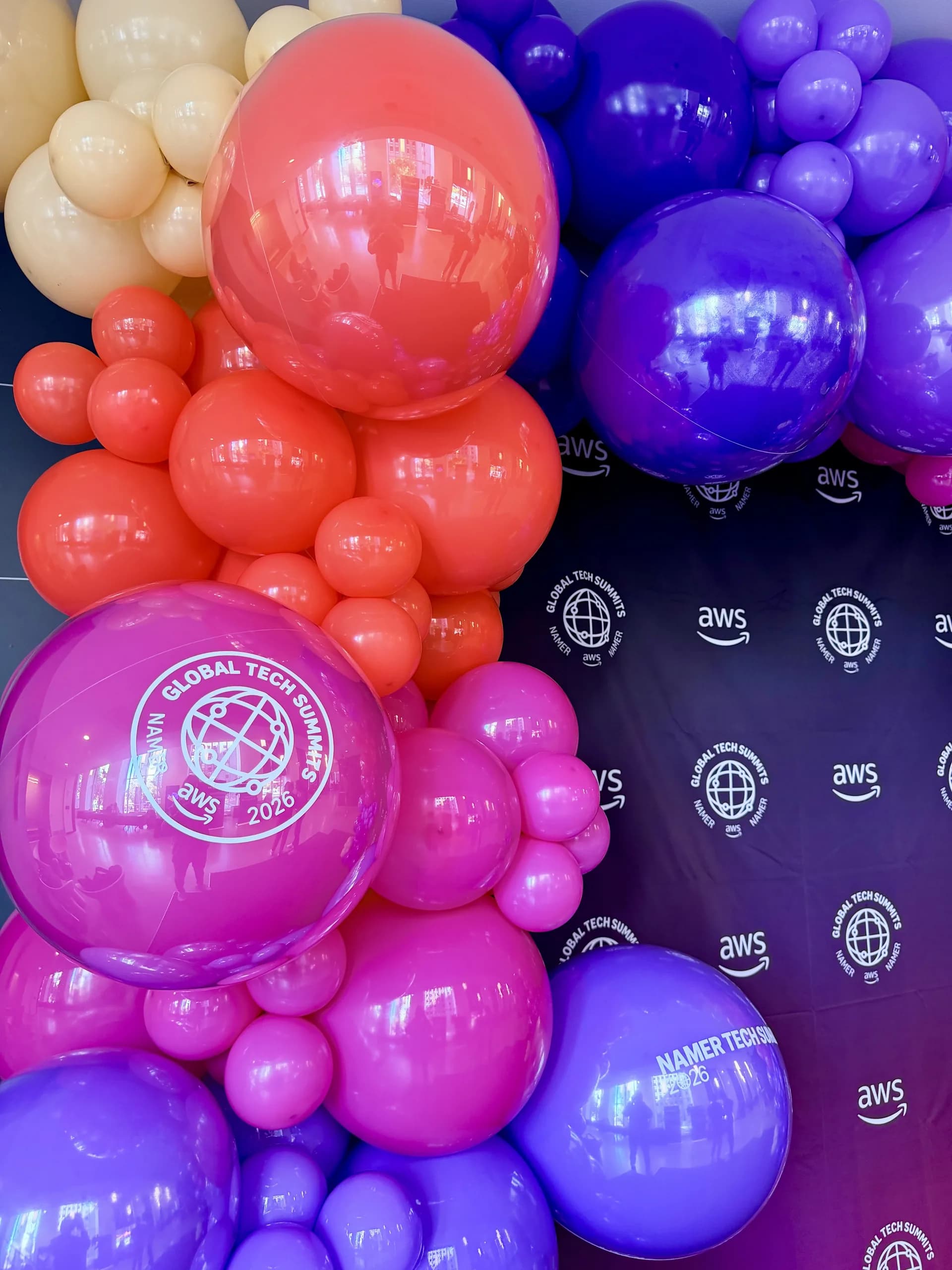 Two statement balloon arches and a branded photo zone installed on site for the Tech Summit 2026 in San Francisco, California, frame 5 of 8.