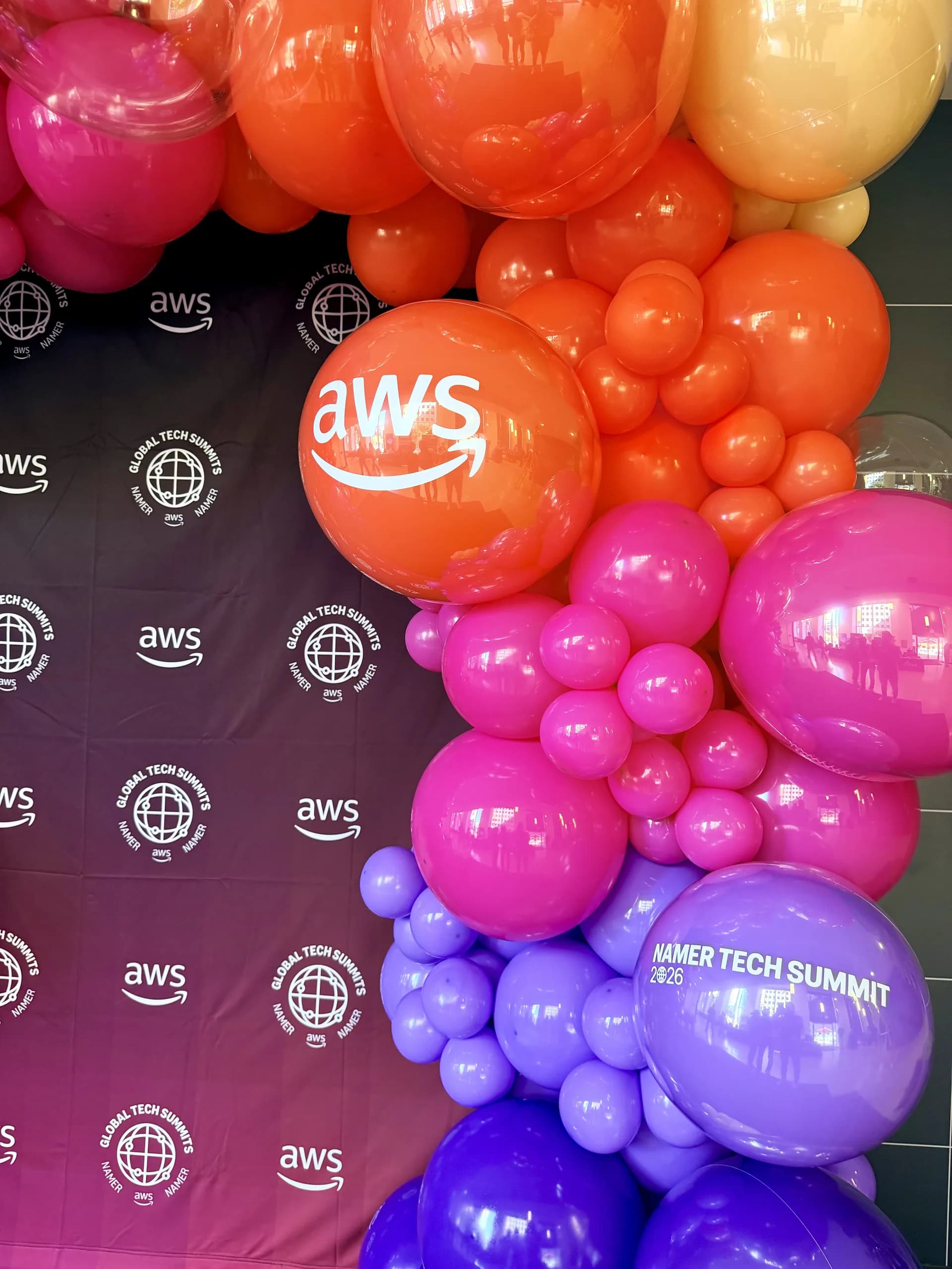 Two statement balloon arches and a branded photo zone, Tech Summit 2026, San Francisco, California — view 7 of 8.