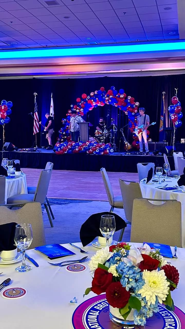 Corporate Awards Night in San Francisco Peninsula: stage balloon arch and helium bouquets, view 2 of 4.