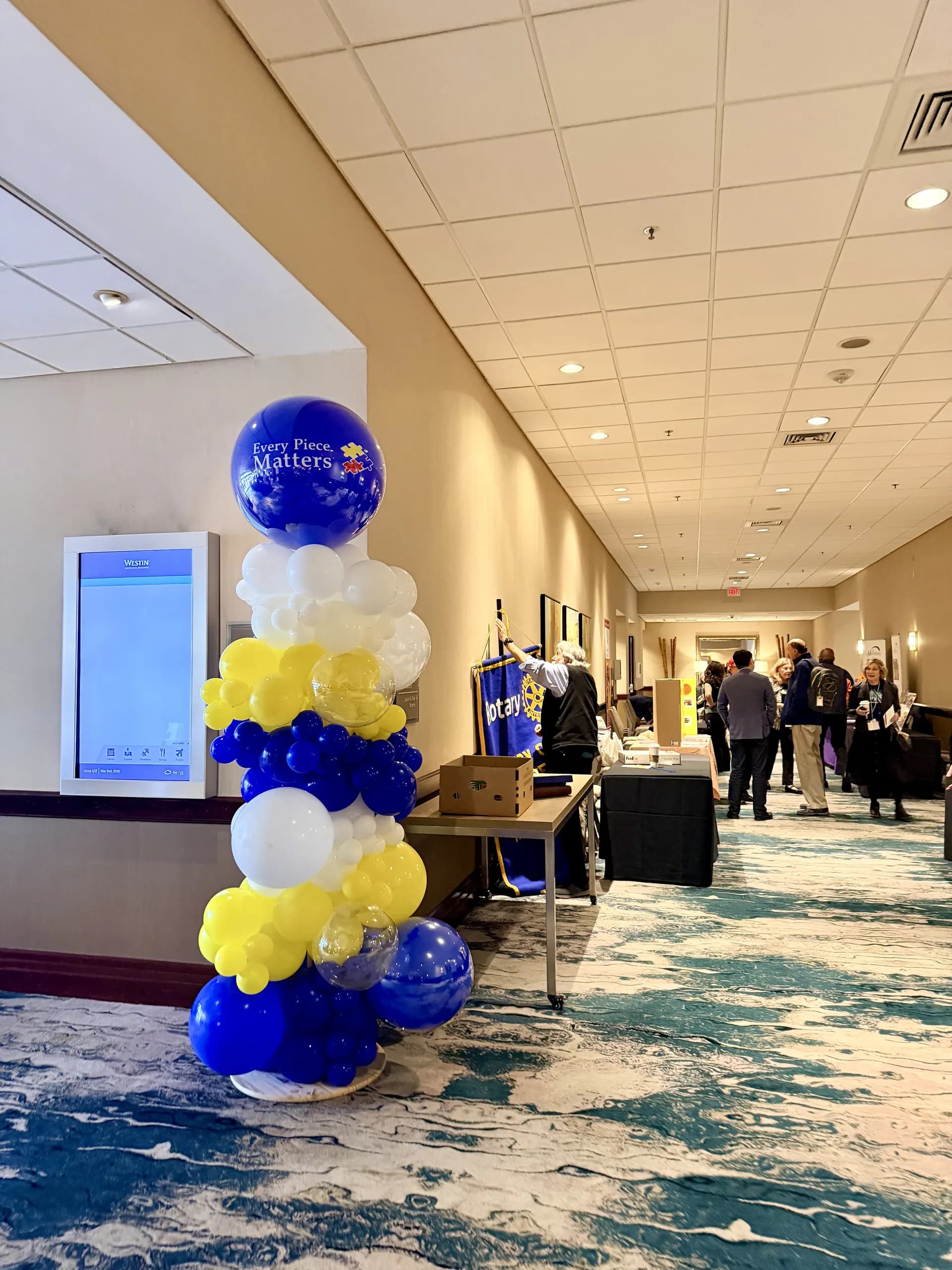 Corporate event décor by Balloon Décor: branded balloon columns and helium bouquets in rotary blue, yellow, white and clear, Foster City, California — view 6.