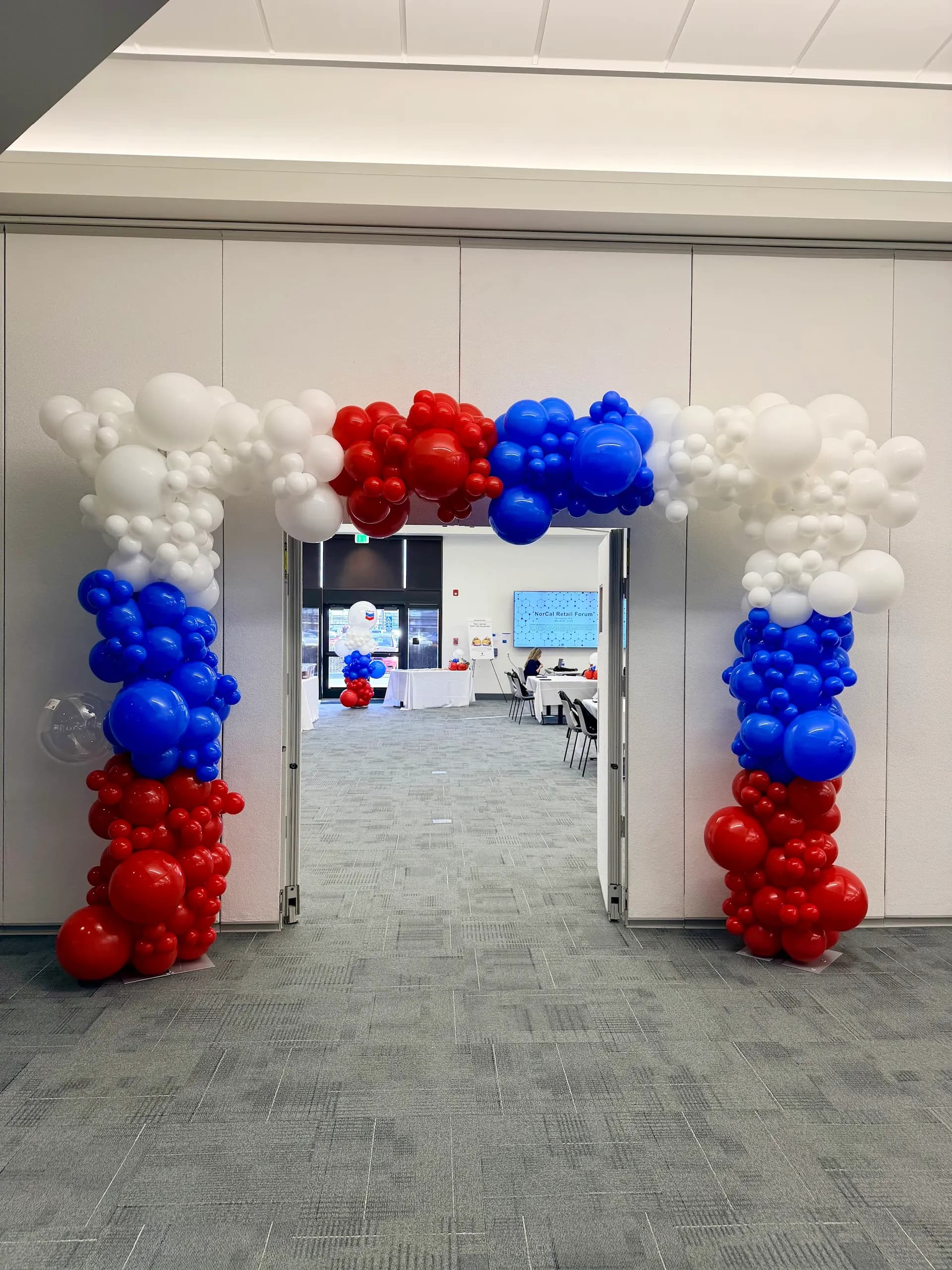 Completed balloon arch and floral balloon centerpieces from the Retail Industry Forum project in Richmond, California (image 4 of 5).