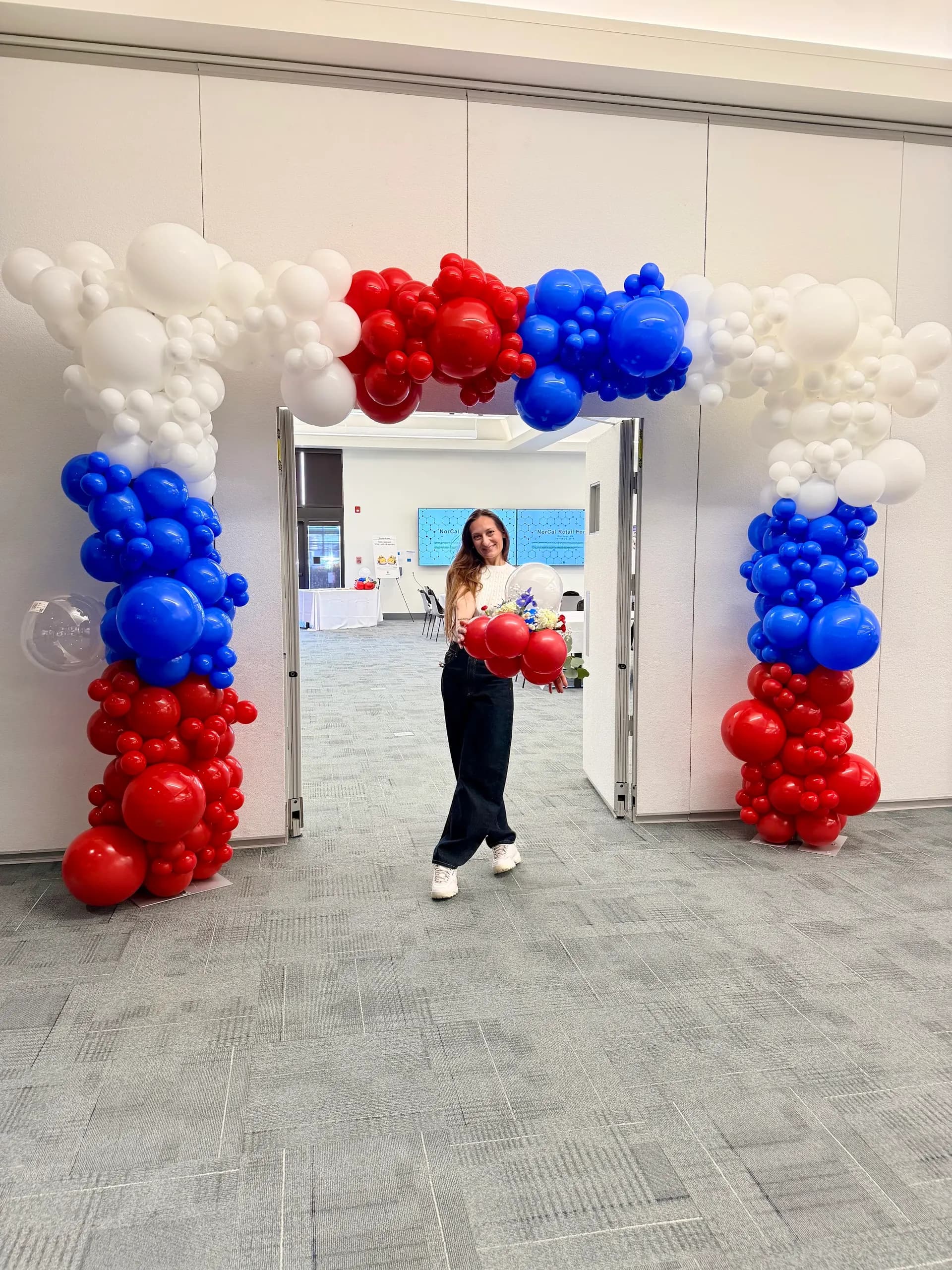 Balloon arch and floral balloon centerpieces installed on site for the Retail Industry Forum in Richmond, California, frame 5 of 5.