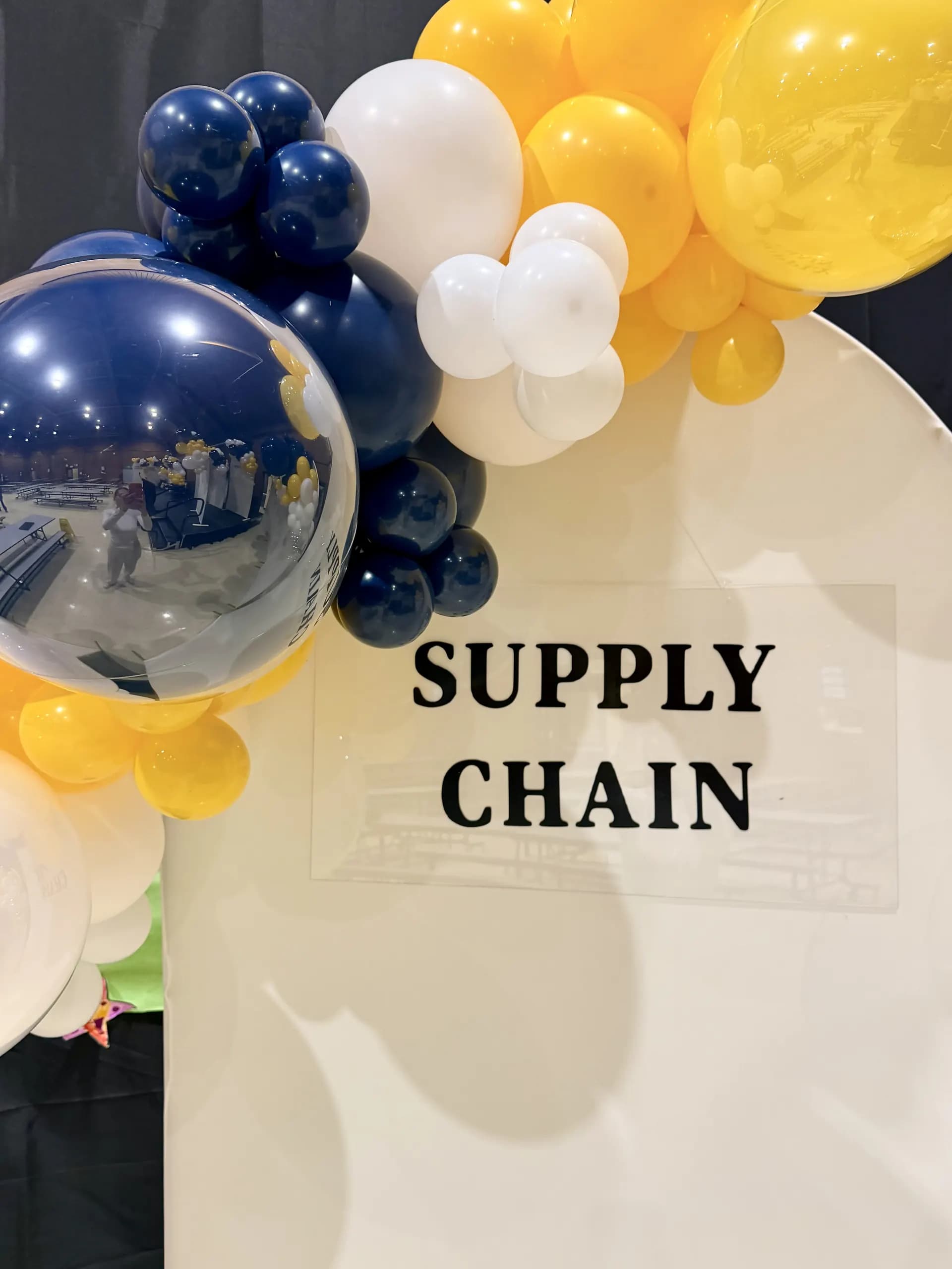 Corporate event décor by Balloon Décor: organic balloon backdrop and career-path arch panels in blue, gold and white, Vallejo, California — view 6.