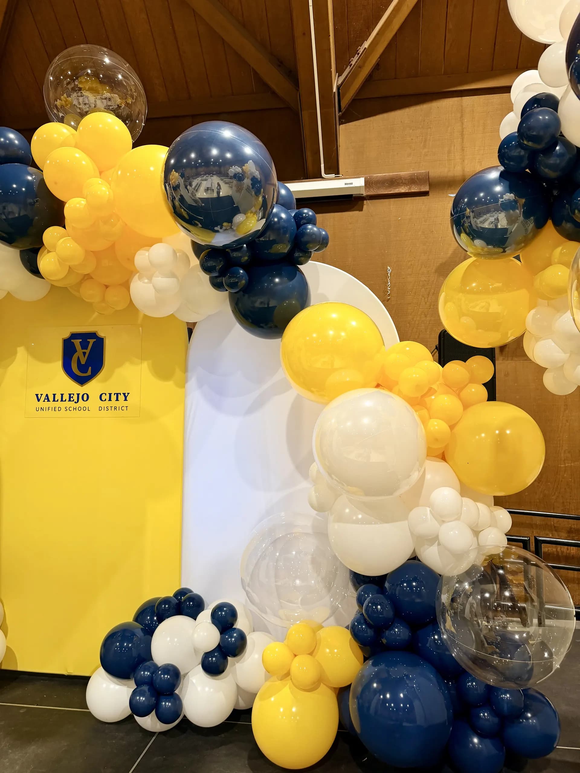 Organic balloon backdrop and career-path arch panels in blue, gold and white, Career Fair, Vallejo, California — view 7 of 8.