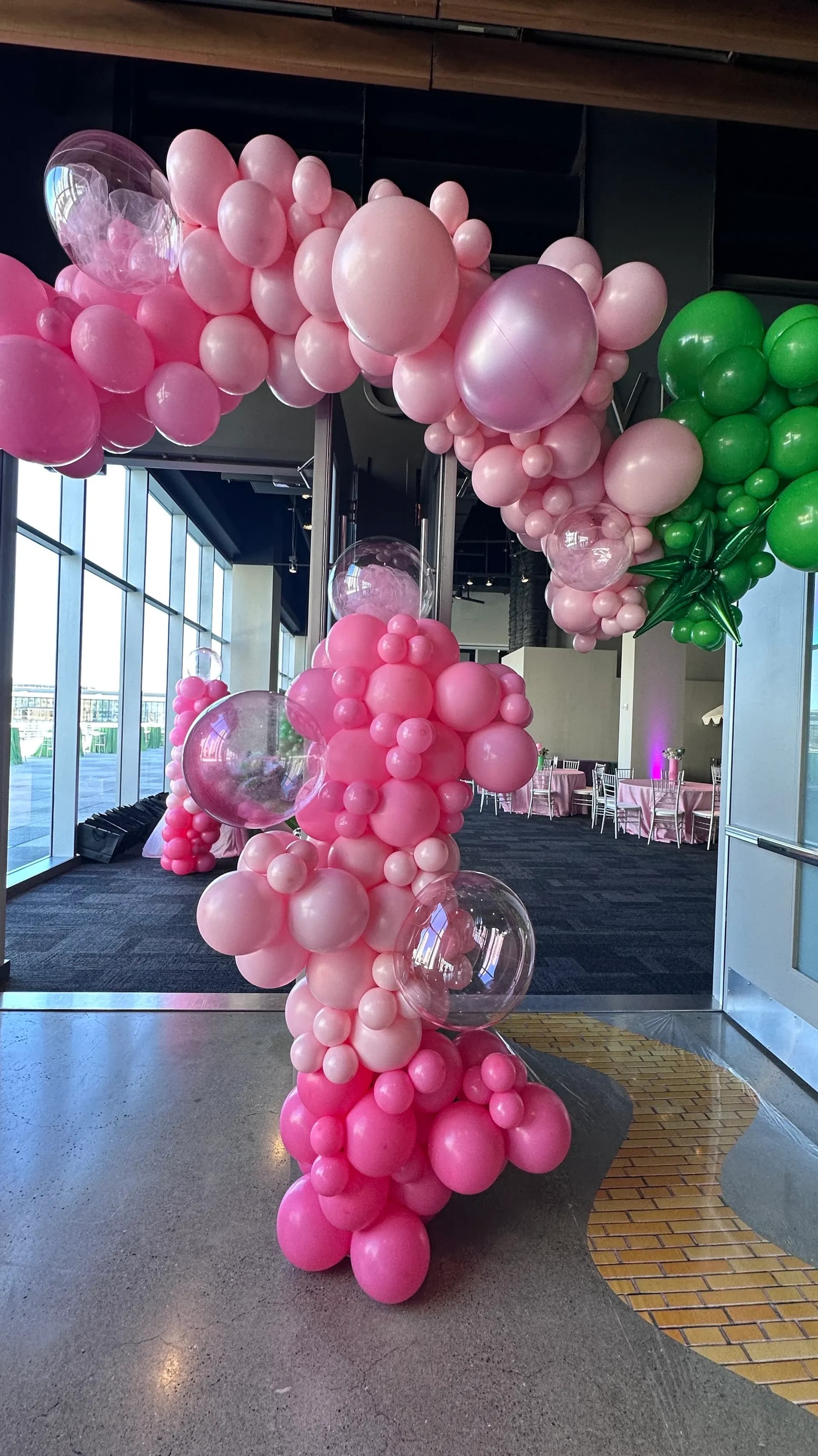 Corporate event décor by Balloon Décor: emerald City and Glinda themed arches and centerpieces in emerald green and pink, San Francisco, California — view 6.