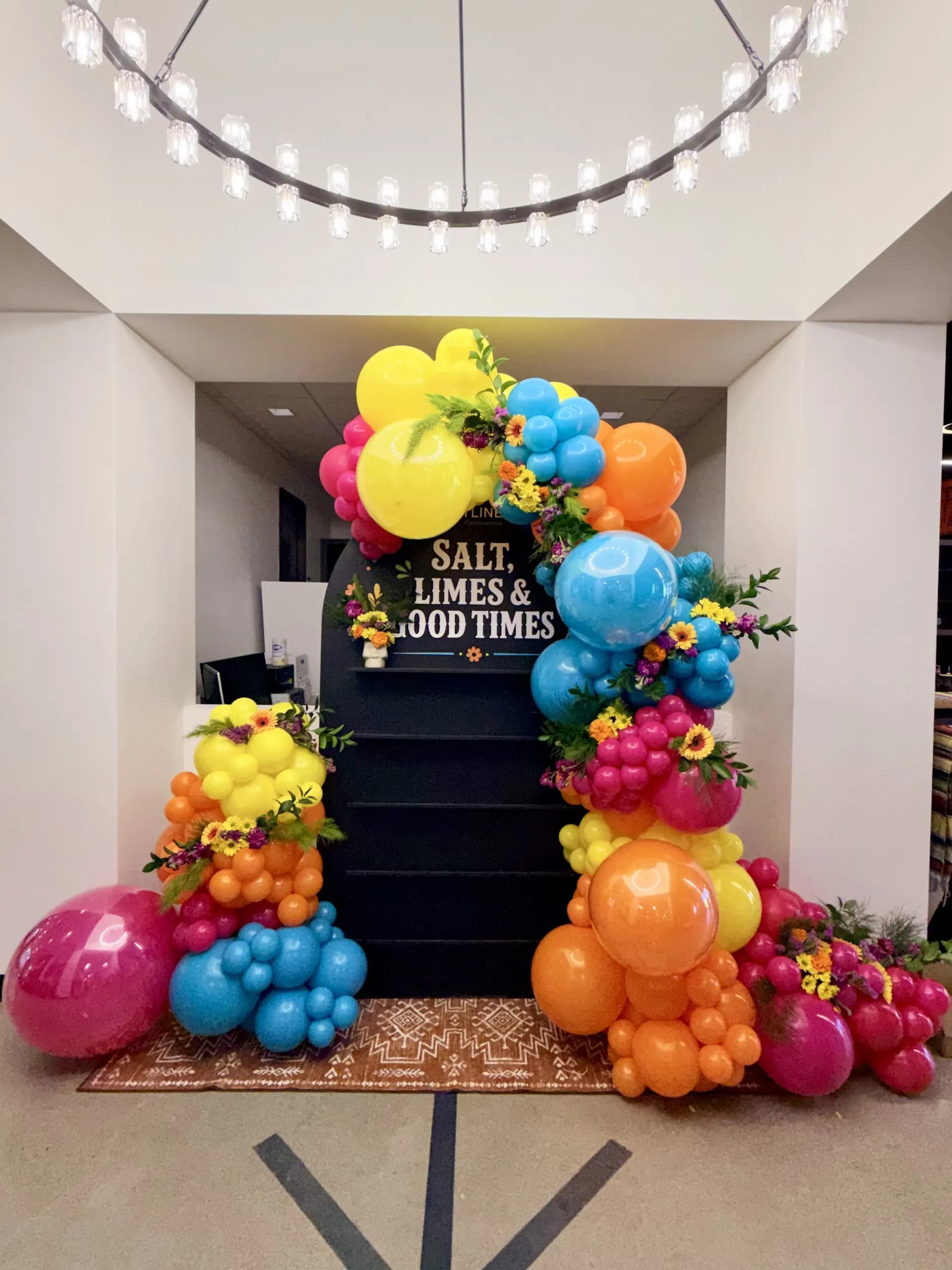 Balloon photo zone with fresh flowers and centerpieces for Skyline Construction at the Office Celebration in San Jose, California.