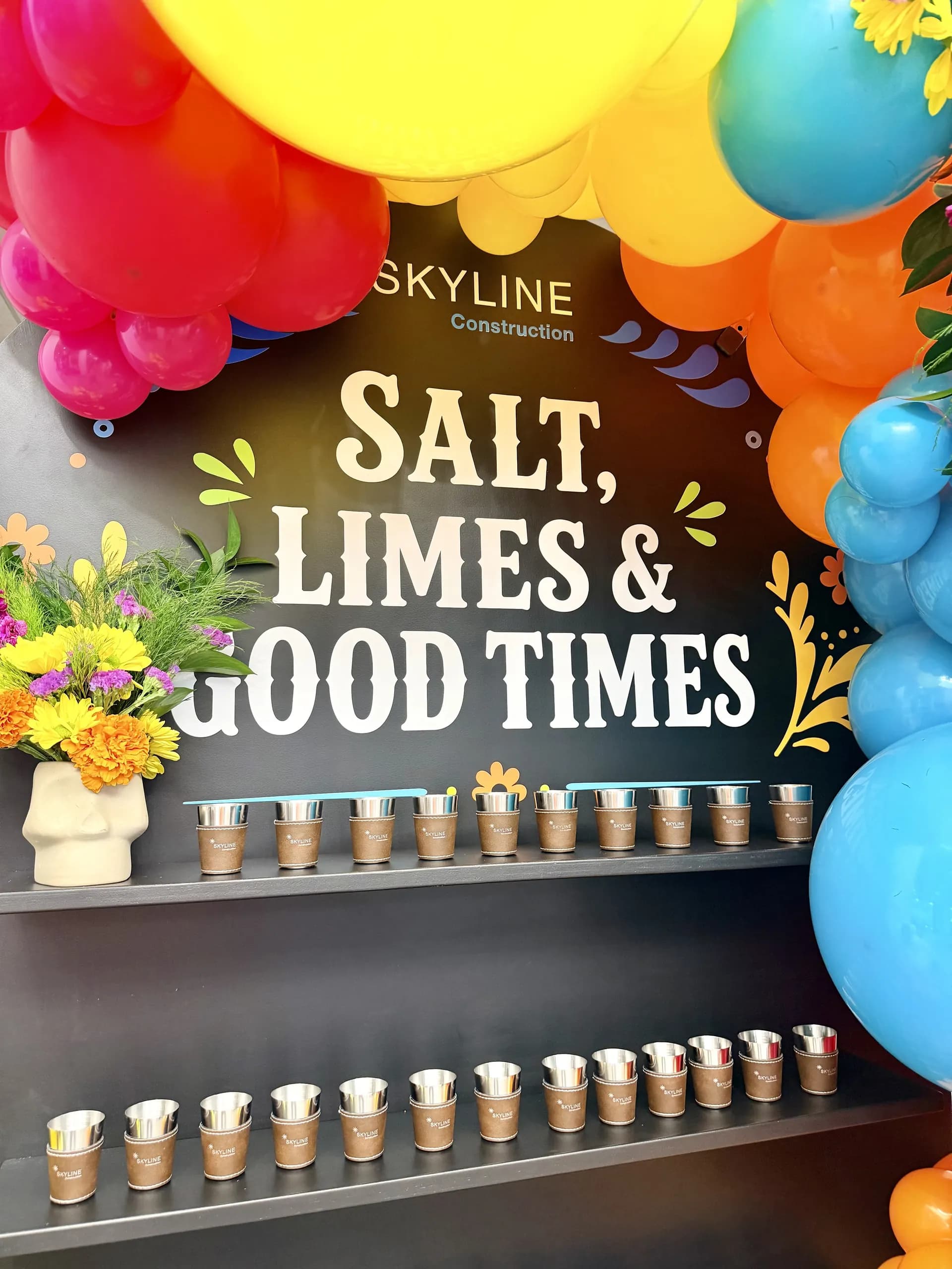 Skyline Construction's Office Celebration in San Jose, California: balloon photo zone with fresh flowers and centerpieces, view 2 of 8.