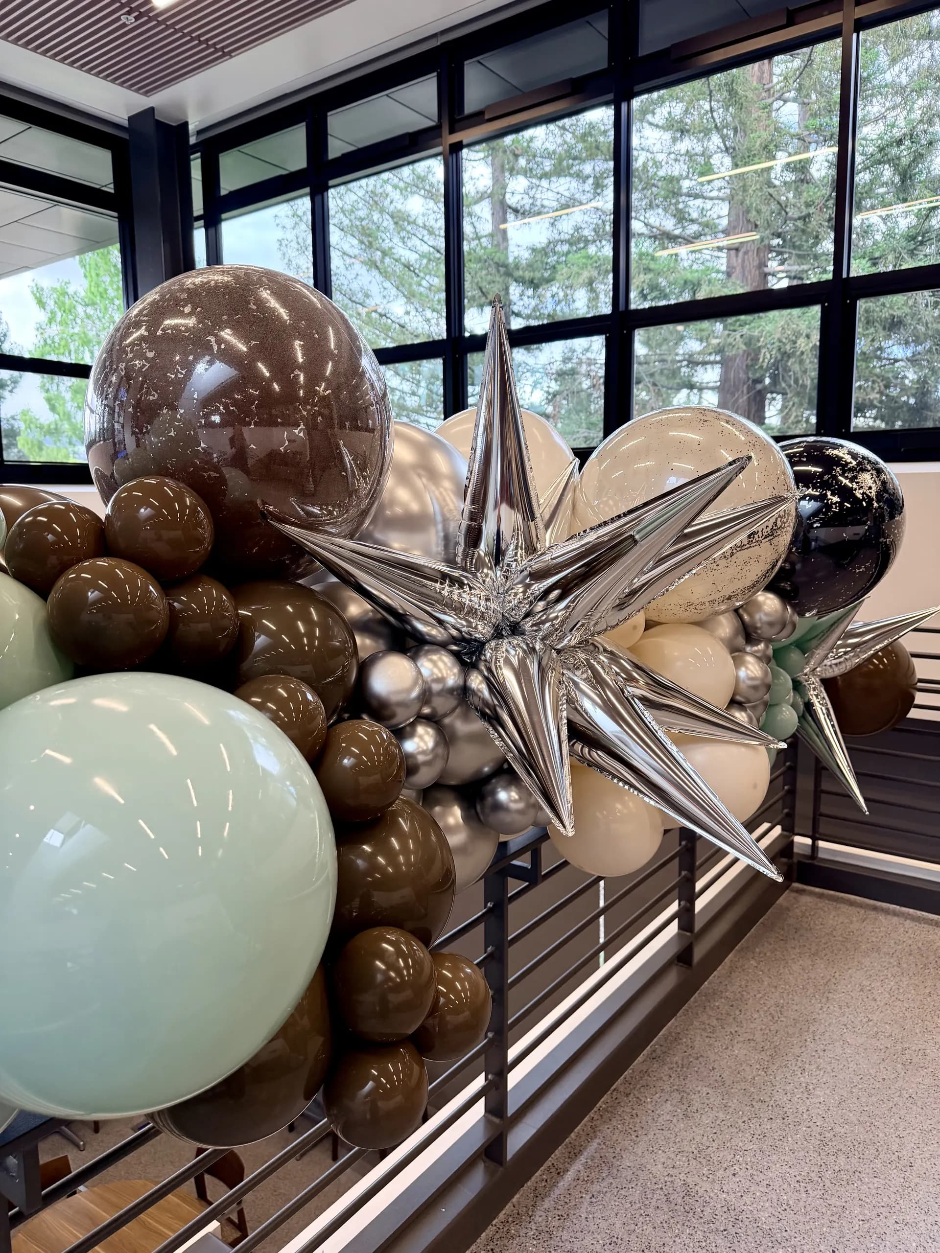 Large-scale entrance balloon arch and interior balloon installation, Grand Opening, Redwood City, California — view 7 of 8.